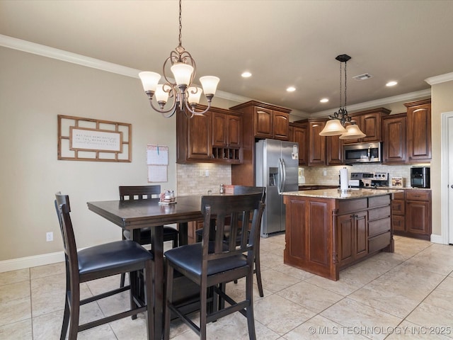 5406 Ashbrook Dr, Bartlesville, OK 74006 - kitchen featuring crown molding, appliances with stainless steel finishes, an inviting chandelier, backsplash, and visible vents