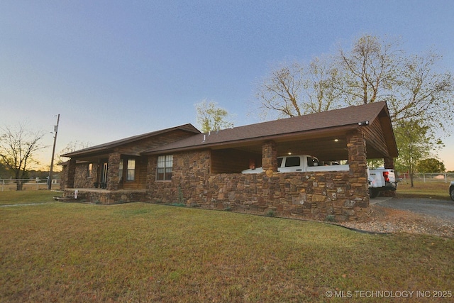 view of home's exterior featuring fence, a yard, and stone siding