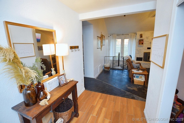 corridor featuring baseboards and wood finished floors