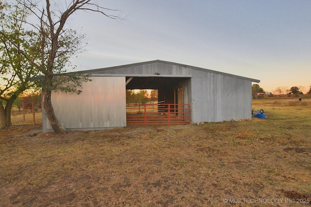 outdoor structure at dusk featuring an outdoor structure and a pole building