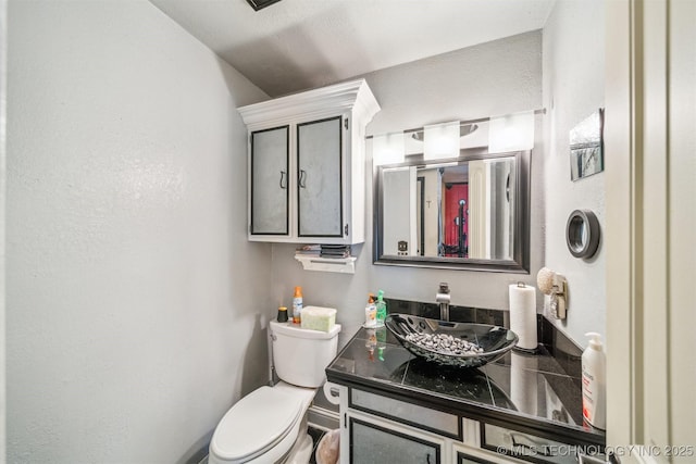 bathroom with toilet and vanity