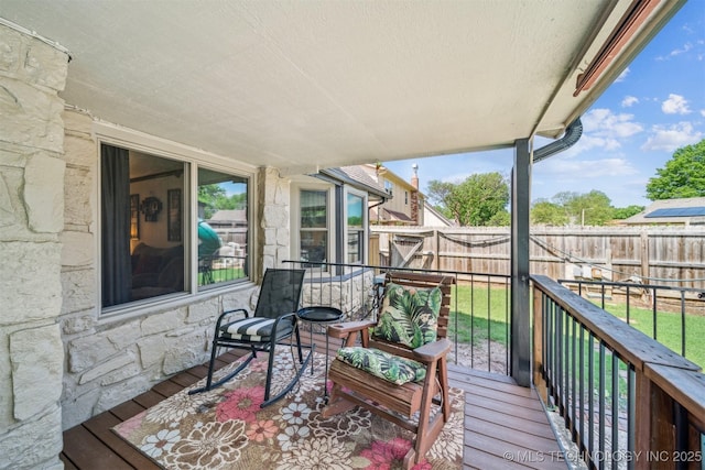 wooden deck featuring a fenced backyard