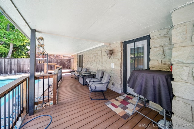 wooden deck featuring a fenced in pool and a fenced backyard