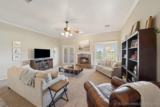 carpeted living room featuring visible vents, crown molding, baseboards, and ceiling fan
