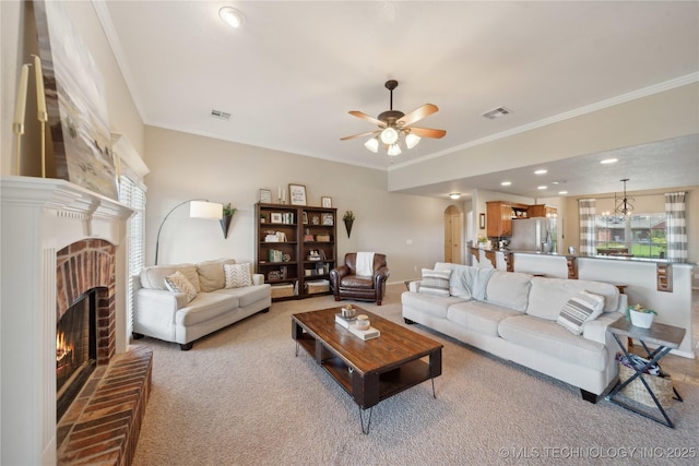 living room with light colored carpet, crown molding, and a fireplace