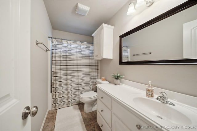 full bathroom with vanity, tile patterned floors, curtained shower, and toilet