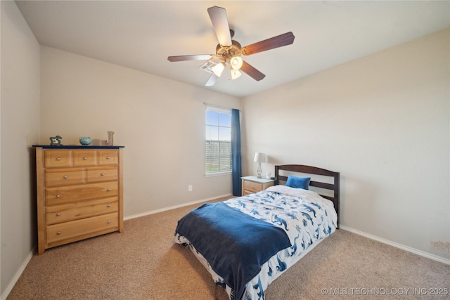 carpeted bedroom featuring baseboards and a ceiling fan