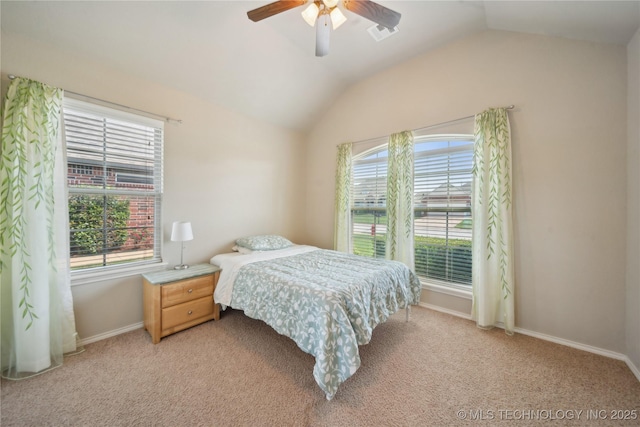 bedroom with baseboards, multiple windows, lofted ceiling, and light carpet