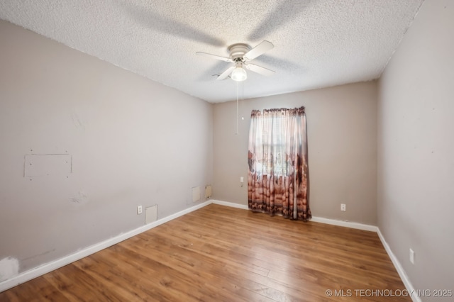 35617 W 261st St S, Bristow, OK 74010 - empty room with a ceiling fan, a textured ceiling, wood finished floors, and baseboards