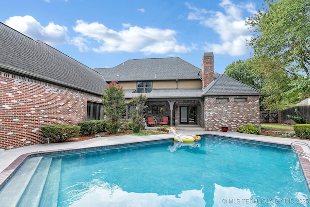 view of swimming pool featuring a fenced in pool, a patio area, and fence