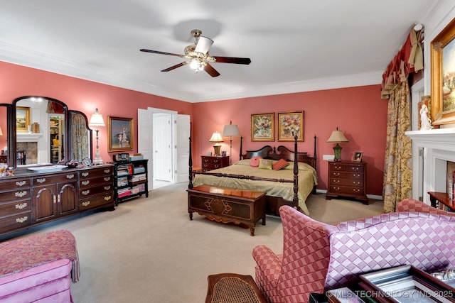 bedroom with carpet floors, crown molding, and a fireplace