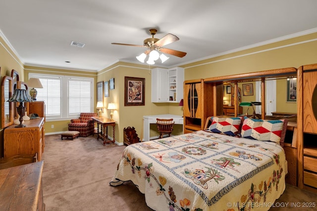 bedroom with crown molding, baseboards, visible vents, and carpet floors