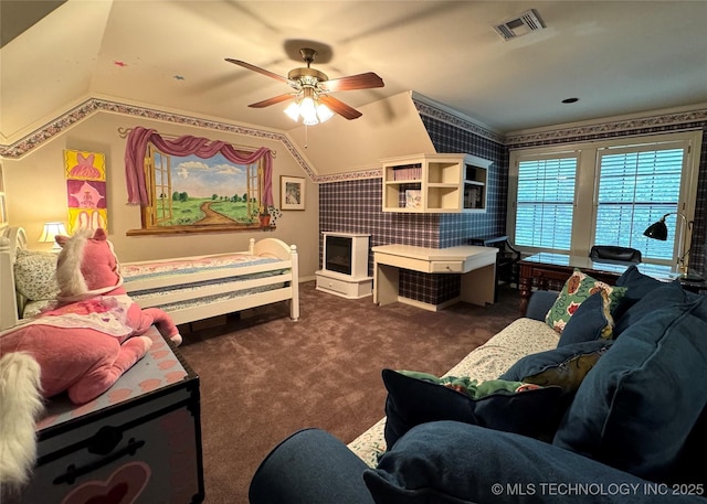 living area with visible vents, lofted ceiling, dark carpet, wallpapered walls, and a ceiling fan