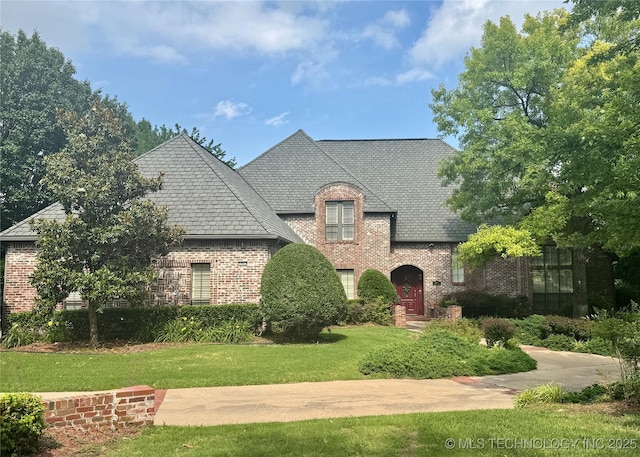 10623 S Oxford Ave, Tulsa, OK 74137 - french provincial home featuring brick siding, a front yard, and a high end roof