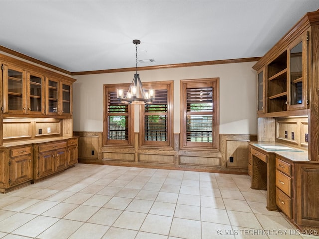 unfurnished dining area featuring visible vents, crown molding, wainscoting, light tile patterned floors, and a notable chandelier