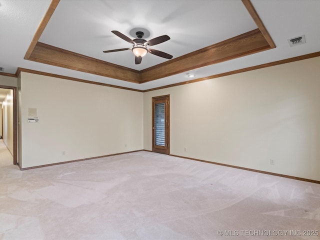 unfurnished room featuring visible vents, ornamental molding, and a tray ceiling