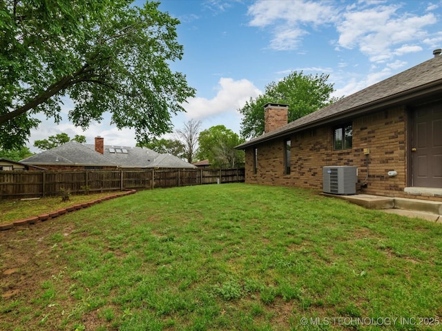 view of yard with central AC unit and a fenced backyard