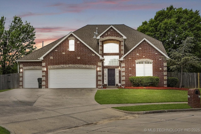 view of front facade with a shingled roof, fence, an attached garage, and brick siding