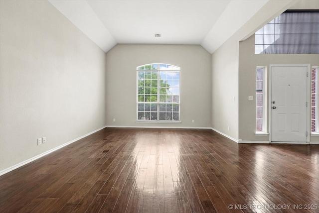interior space featuring baseboards, visible vents, dark wood finished floors, and lofted ceiling