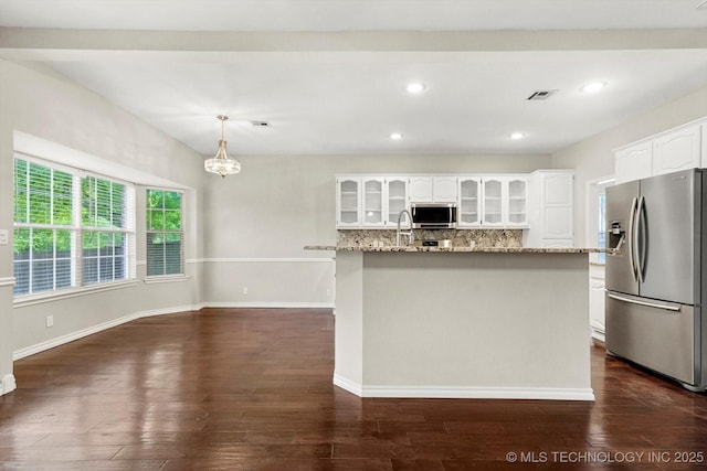 kitchen featuring backsplash, light stone countertops, glass insert cabinets, stainless steel appliances, and white cabinetry