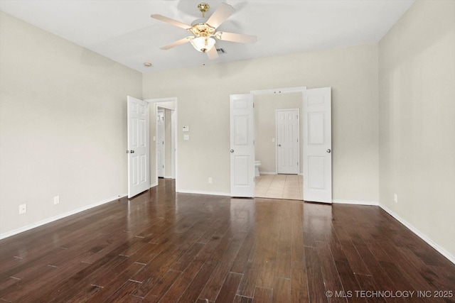 unfurnished bedroom with a ceiling fan, baseboards, and wood finished floors