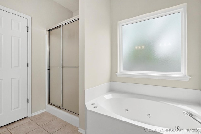 bathroom featuring a jetted tub, tile patterned floors, and a shower stall