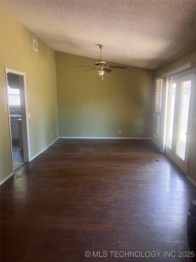 2640 W Fort Worth Pl, Broken Arrow, OK 74012 - unfurnished room with ceiling fan, dark wood finished floors, vaulted ceiling, a textured ceiling, and baseboards