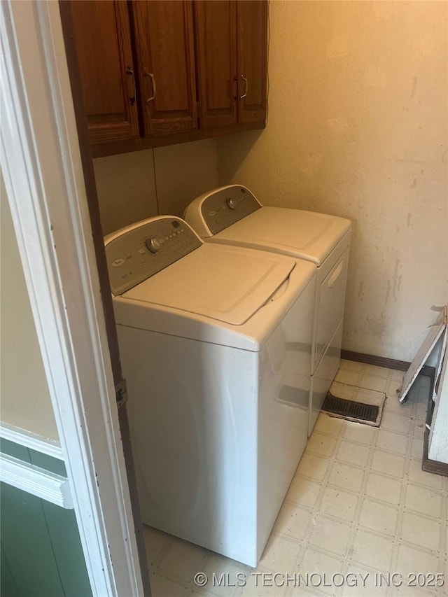 2640 W Fort Worth Pl, Broken Arrow, OK 74012 - laundry area featuring washing machine and clothes dryer, light floors, and cabinet space