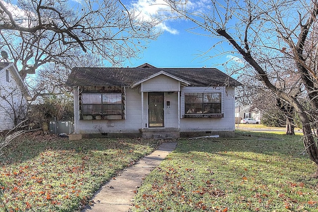 bungalow featuring a shingled roof, a front yard, and crawl space