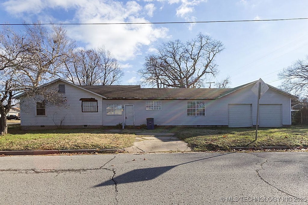 view of front of property with a garage, aphalt driveway, and crawl space