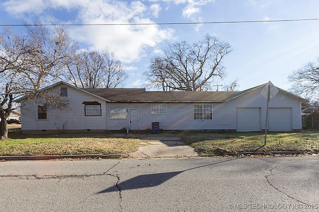 view of front of property with a garage, aphalt driveway, and crawl space