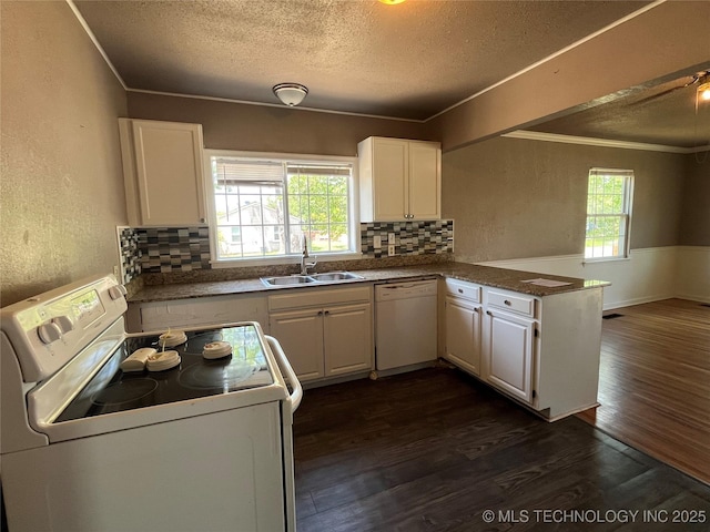 304 E 45th Ct, Tulsa, OK 74105 - kitchen featuring white appliances, a sink, a textured ceiling, dark wood-style flooring, and a peninsula