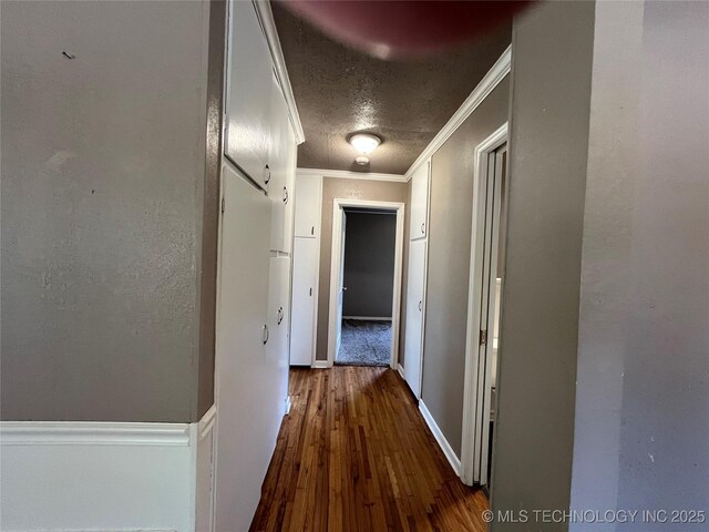 304 E 45th Ct, Tulsa, OK 74105 - hall featuring crown molding, dark wood-style flooring, baseboards, and a textured ceiling