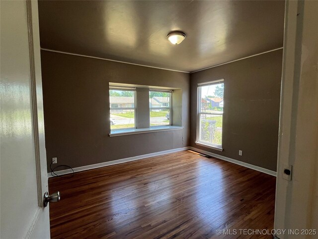 304 E 45th Ct, Tulsa, OK 74105 - unfurnished room with wood finished floors and baseboards