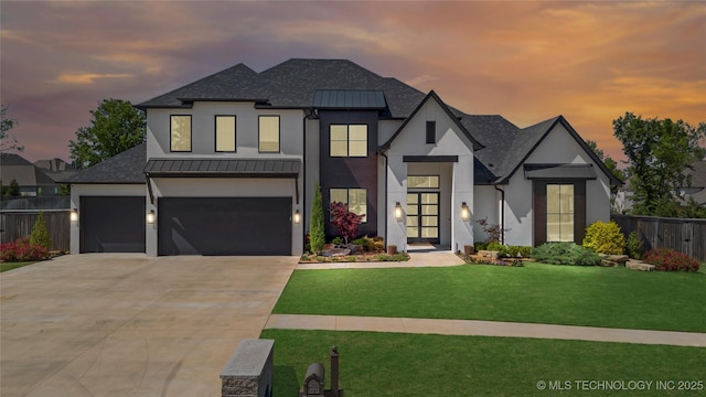 modern inspired farmhouse featuring a standing seam roof, fence, concrete driveway, a shingled roof, and stucco siding