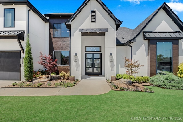 entrance to property with a shingled roof, stucco siding, a standing seam roof, a lawn, and metal roof