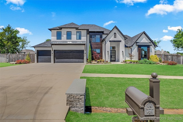 view of front of property with stucco siding, a front lawn, fence, and driveway