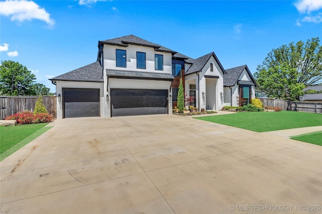 view of front of home with roof with shingles, stucco siding, a front yard, and fence
