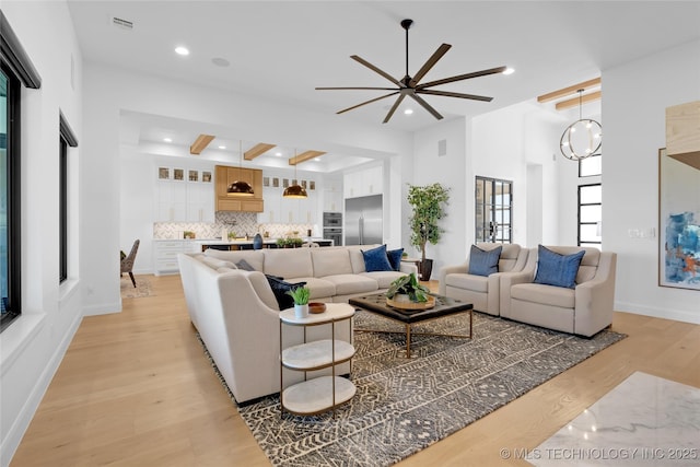 living area with light wood-style floors, a ceiling fan, recessed lighting, and visible vents
