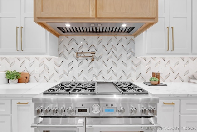 kitchen featuring backsplash, white cabinetry, and double oven range