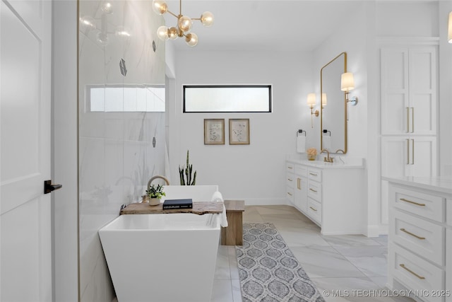 bathroom with baseboards, walk in shower, a soaking tub, and vanity
