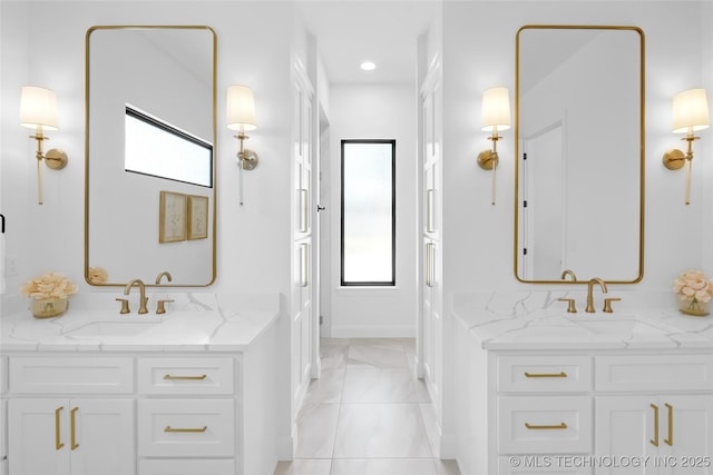 full bath featuring a sink, two vanities, recessed lighting, and marble finish floor