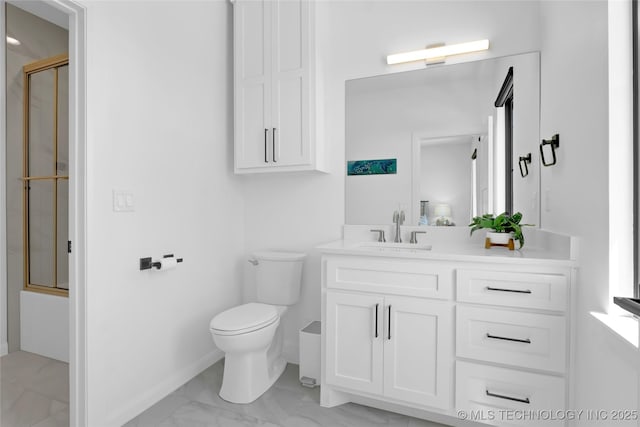 full bathroom featuring baseboards, marble finish floor, toilet, and vanity