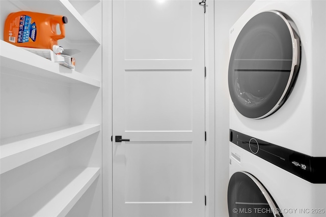 clothes washing area featuring stacked washer / drying machine