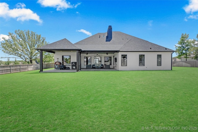 rear view of property featuring a patio, ceiling fan, a chimney, and a fenced backyard
