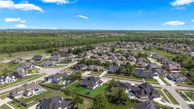 birds eye view of property with a residential view and a wooded view