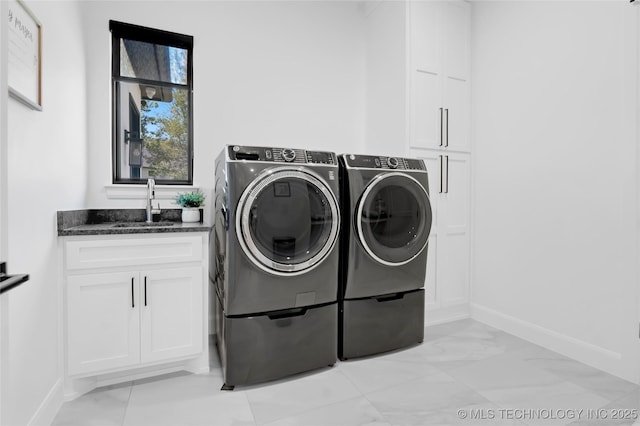 laundry area with cabinet space, a sink, marble finish floor, baseboards, and washing machine and dryer