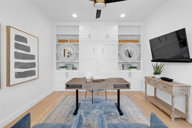 office space with built in features and light wood finished floors