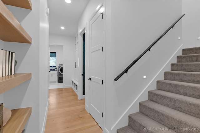 stairs with visible vents, wood finished floors, baseboards, washer / clothes dryer, and recessed lighting
