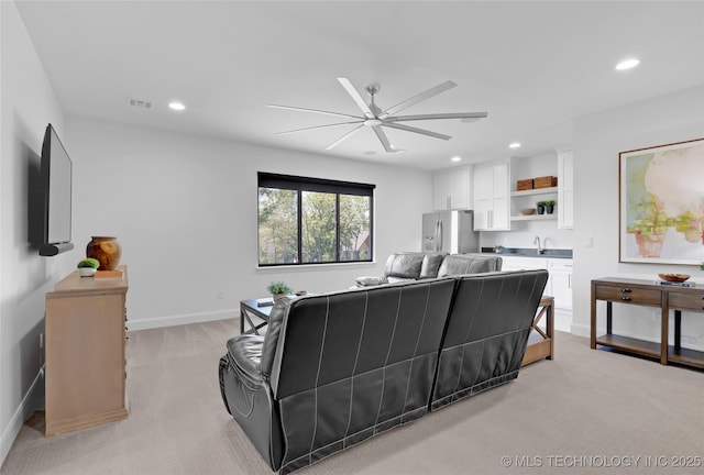 living room with ceiling fan, light colored carpet, recessed lighting, and visible vents